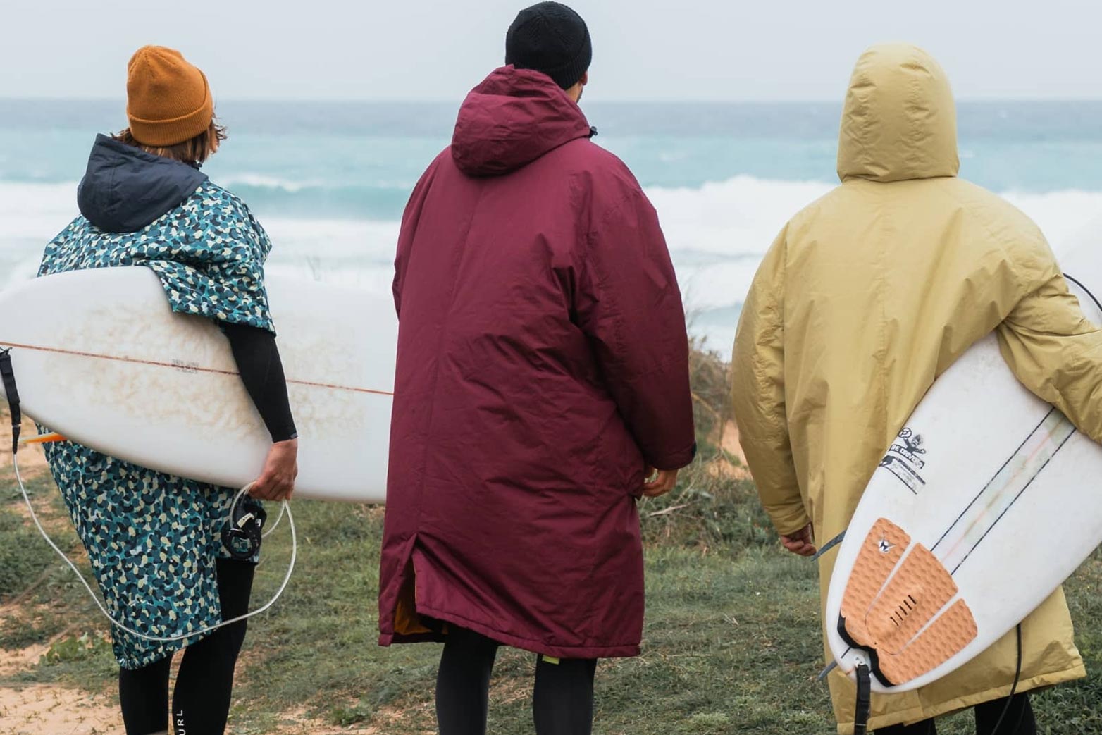 Surfers wearing change robes made with recycled materials.